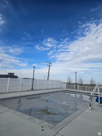 CLUBHOUSE View of swimming pool with a covered pool and a fenced backyard