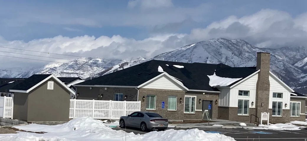 CLUBHOUSE featuring a mountain view, a chimney, and brick siding