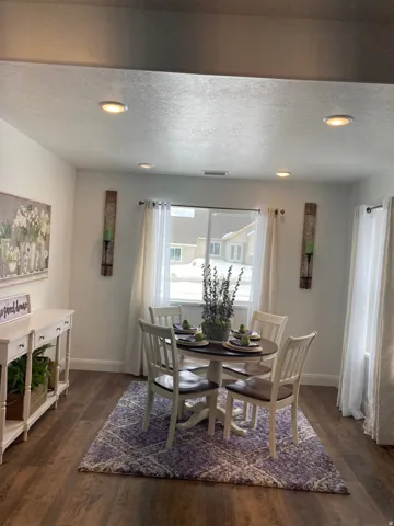MODEL Dining space with recessed lighting, dark wood finished floors, and a textured ceiling