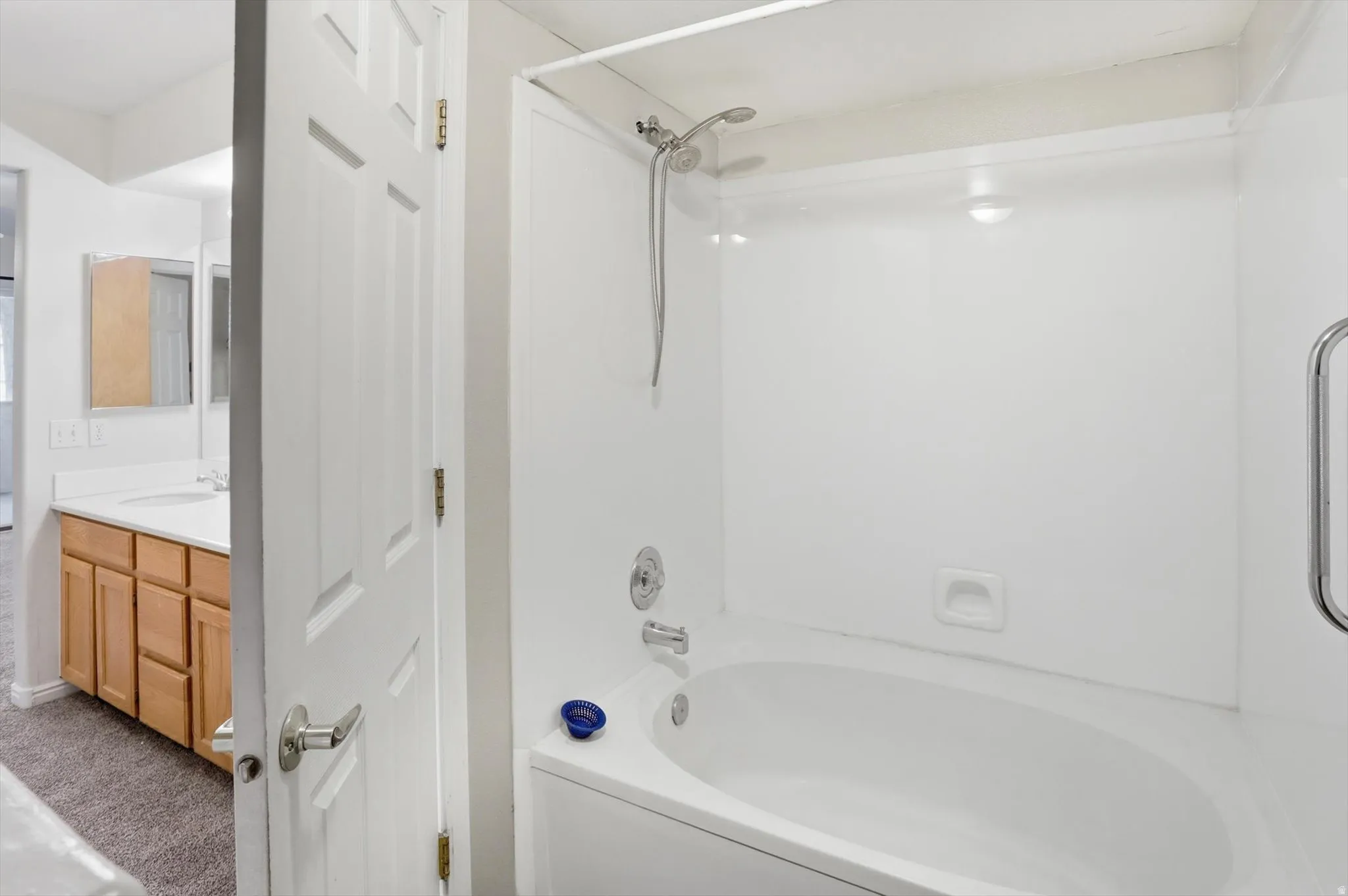 Master Bathroom featuring oversized bathtub / shower combination and vanity