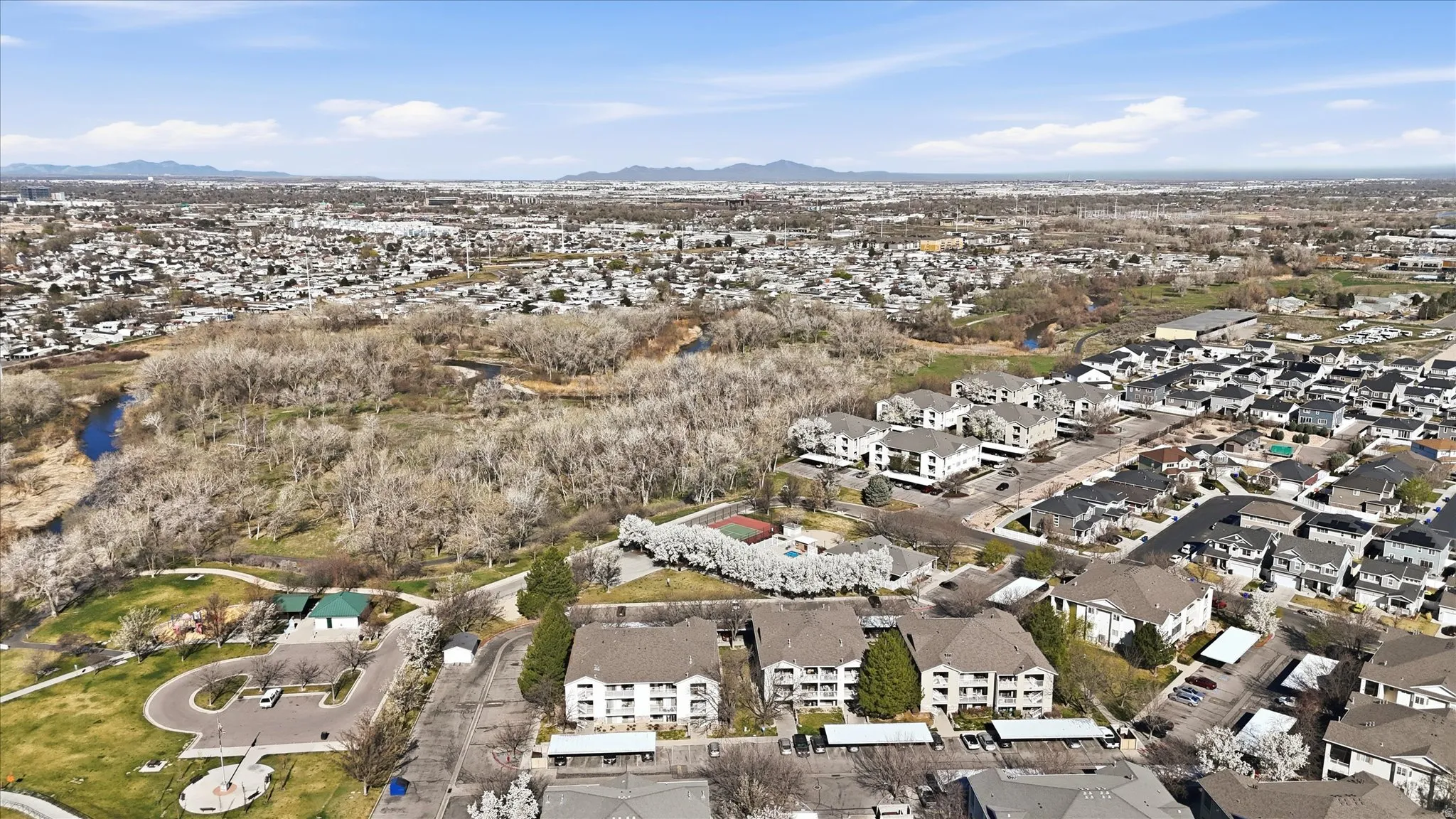 Aerial view of property's location with nearby suburban area and a mountainous background