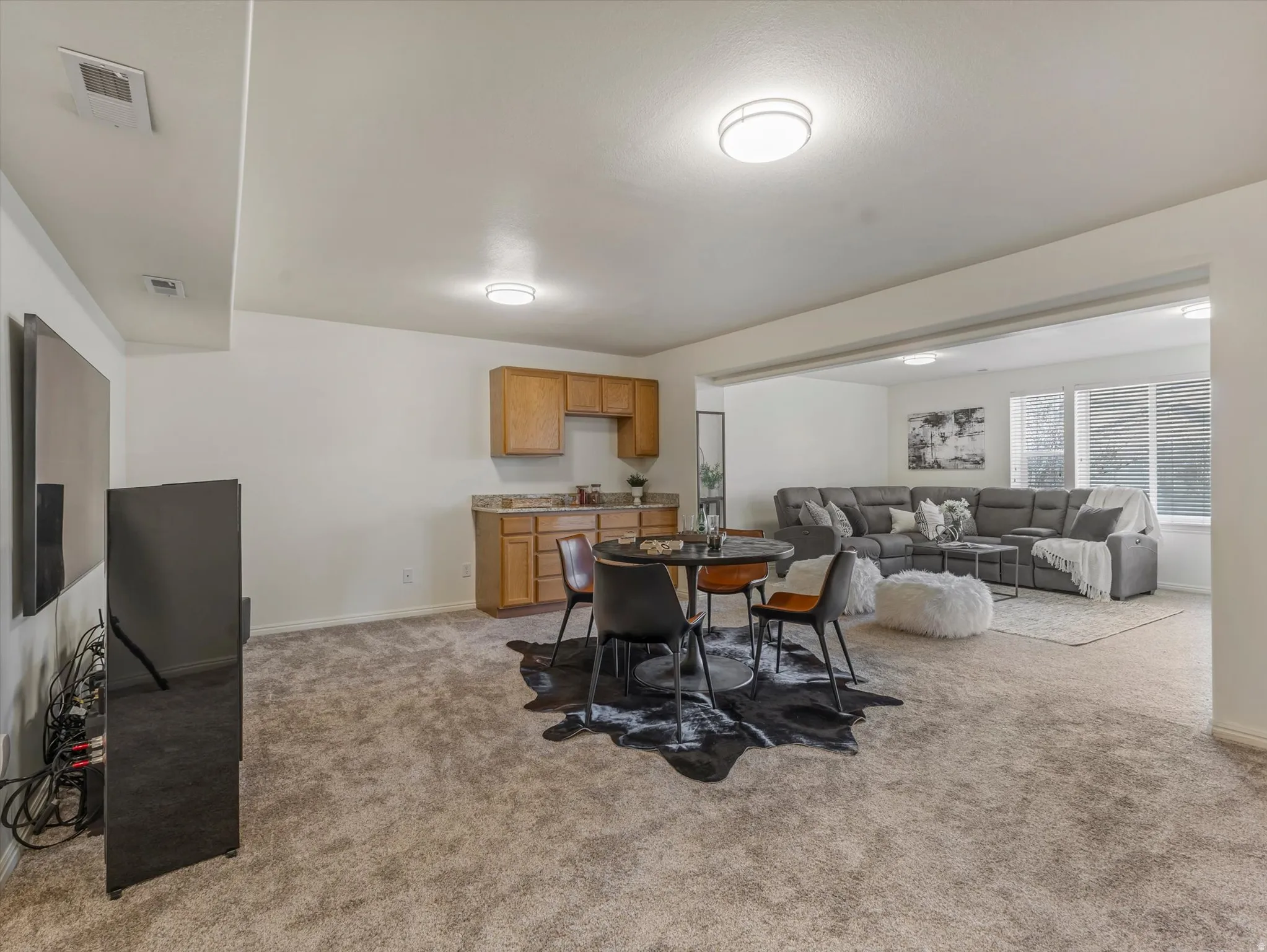 Dining room featuring light carpet and baseboards