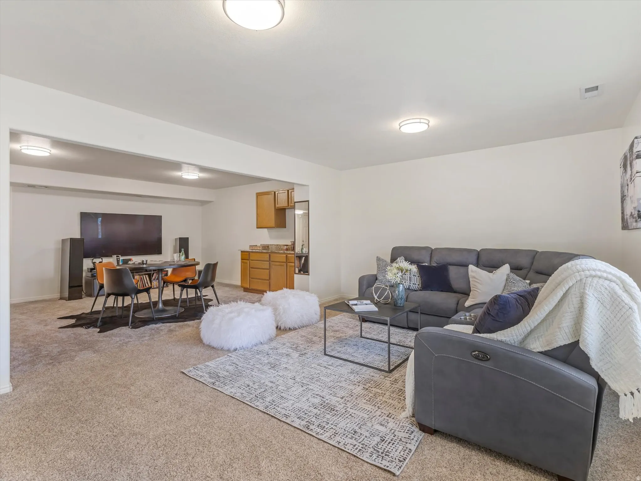 Living room with light colored carpet and a desk