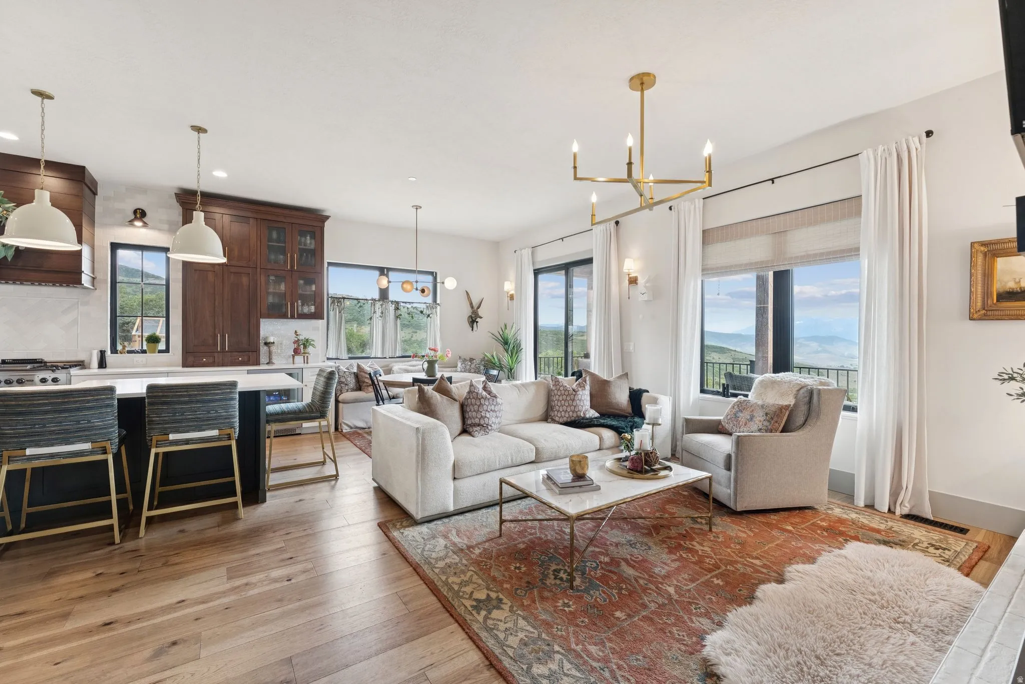 Living area featuring light wood-style flooring and a chandelier