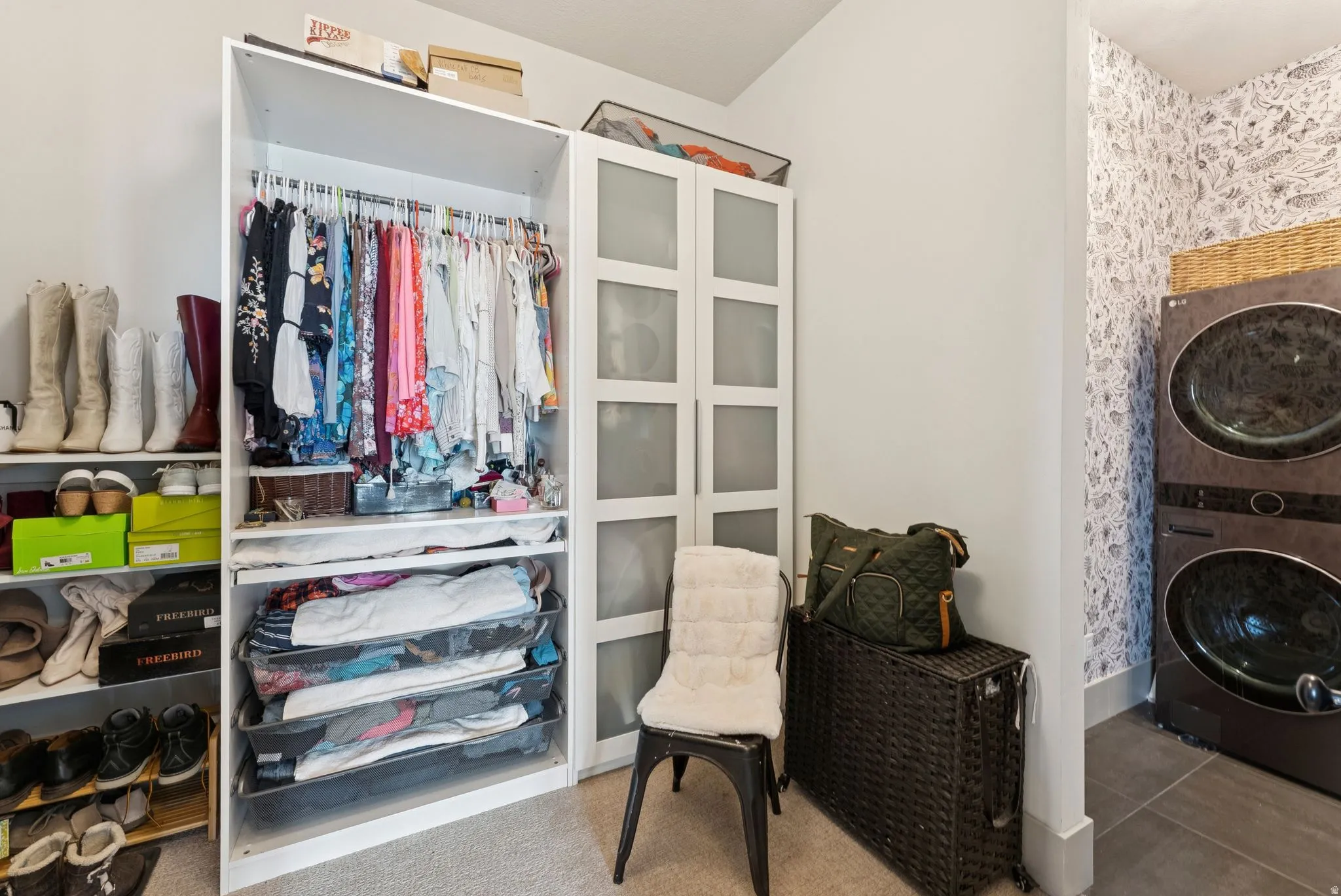 Walk in closet featuring stacked washer and clothes dryer