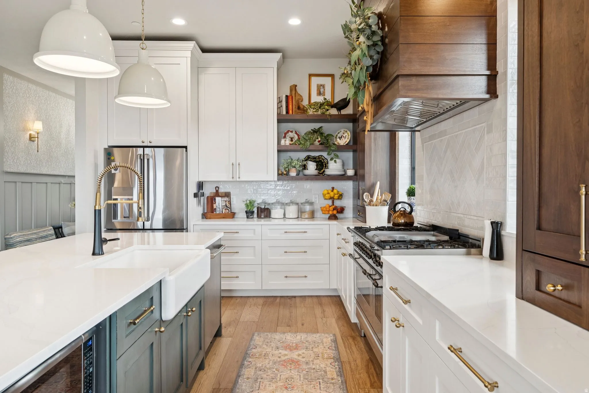 Dual tone kitchen with dual tone cabinetry, stainless steel appliances, open shelves, light wood-style floors, and light stone countertops