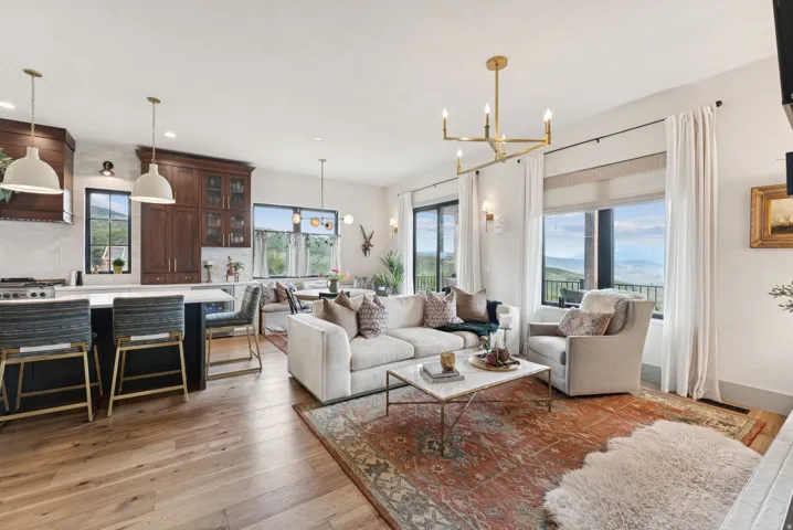 Living area featuring light wood-style flooring and a chandelier