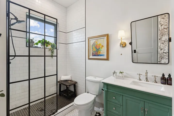 Bathroom featuring vanity and a walk in shower