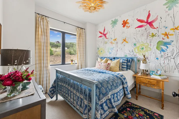 Bedroom with carpet and wallpapered walls