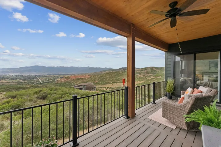Balcony featuring ceiling fan and a mountain view