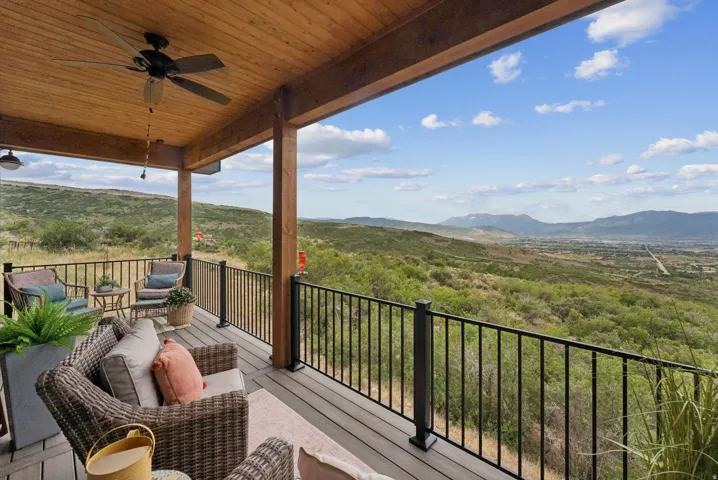 Balcony featuring a ceiling fan, a mountain view, and outdoor furniture