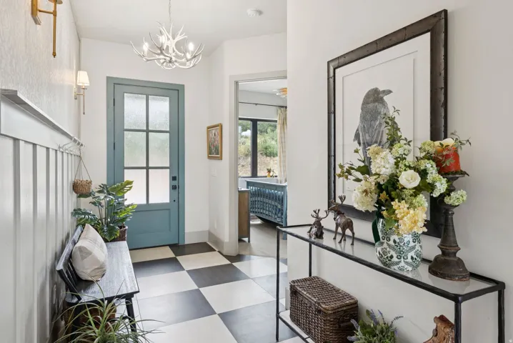 Foyer with dark flooring and a chandelier