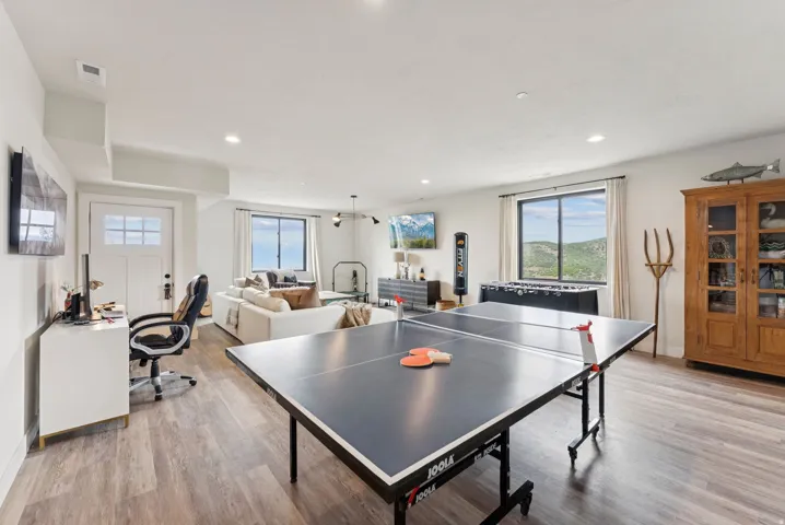 Playroom featuring light wood finished floors, an office area, and recessed lighting
