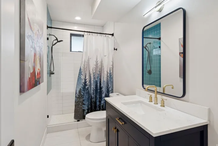 Bathroom with a stall shower, vanity, and light tile patterned flooring