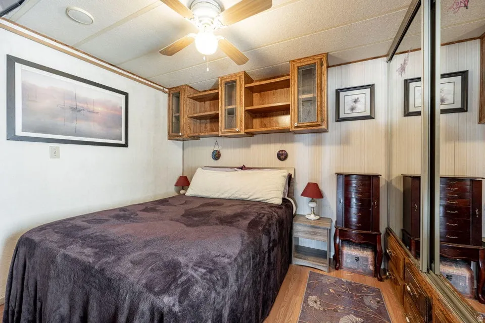 Bedroom featuring wood finished floors and ceiling fan