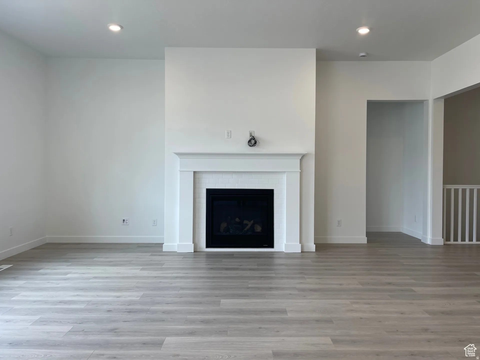 Unfurnished living room featuring recessed lighting, light wood-type flooring, and a fireplace