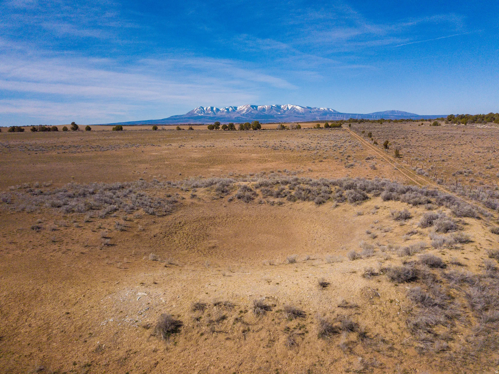 empty seasonal stock pond on the north border of the property facing west to the Blue Mountains
