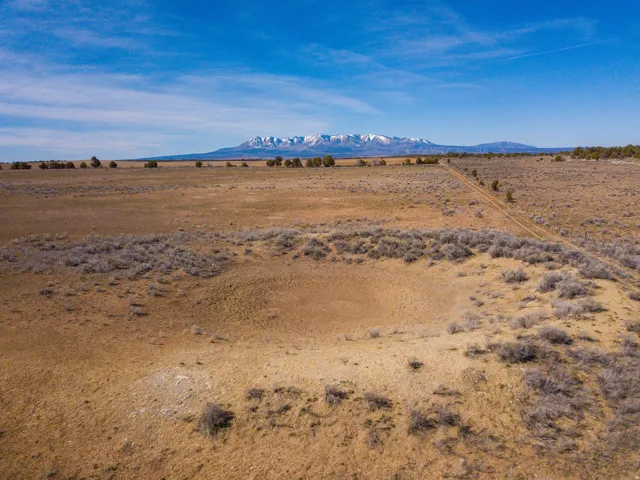 empty seasonal stock pond on the north border of the property facing west to the Blue Mountains