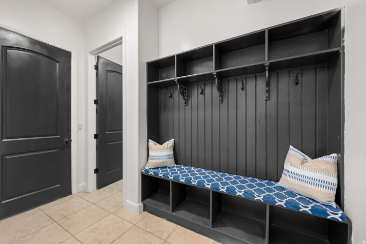 Mudroom with light tile patterned floors and baseboards