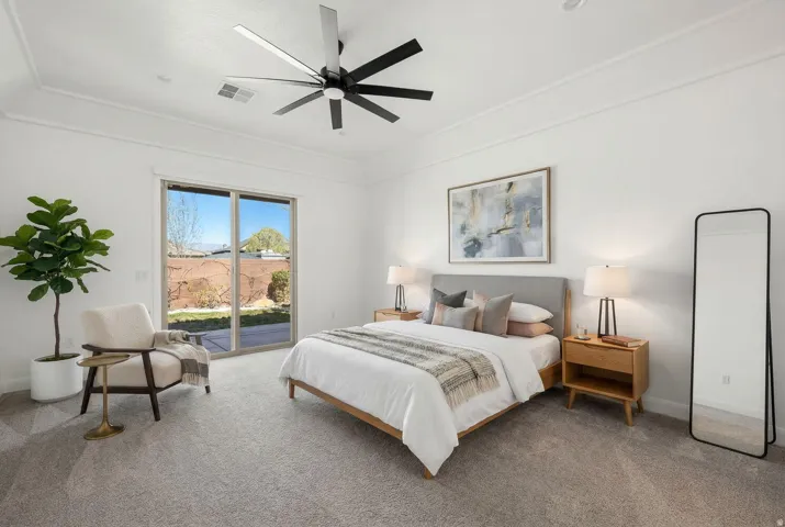Carpeted bedroom with access to outside and a ceiling fan