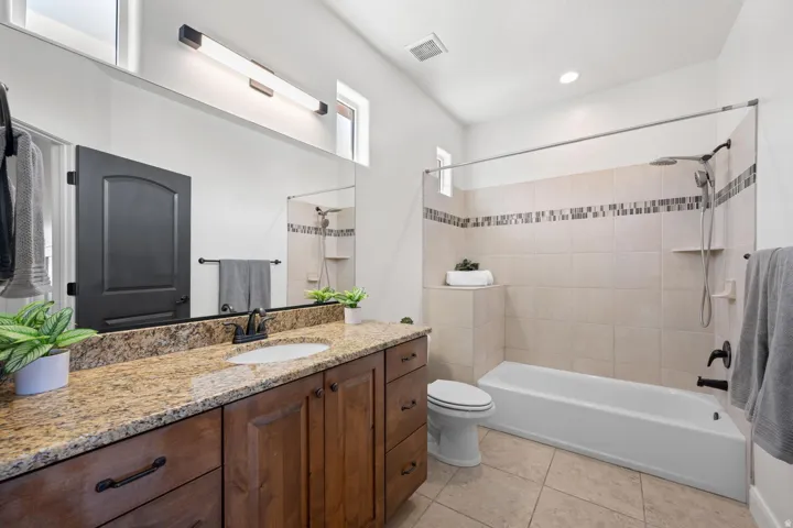 Full bath with vanity, shower / washtub combination, light tile patterned floors, and recessed lighting