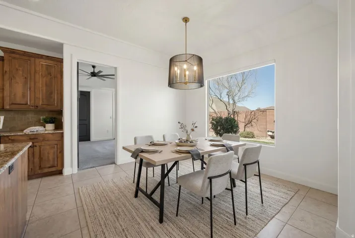 Dining space with hanging lights, ceiling fan, and light tile patterned flooring