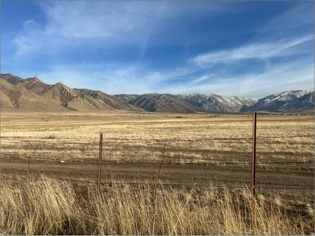 View of mountain background featuring rural landscape