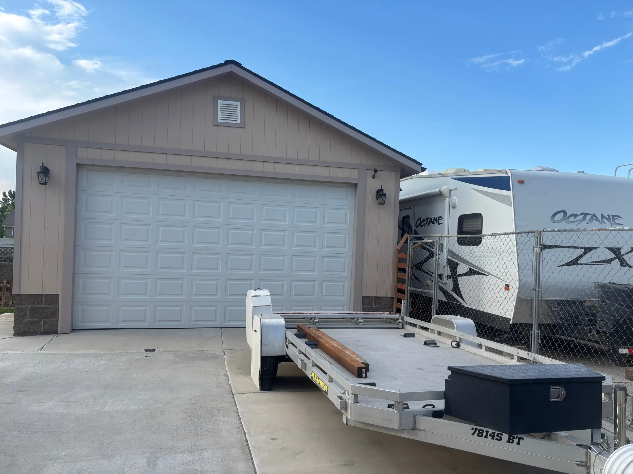 additional Garage featuring long concrete driveway