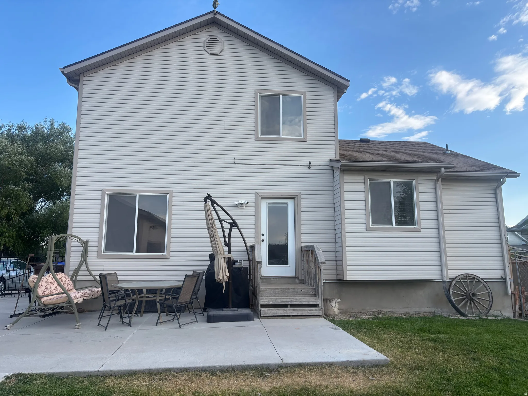Back of house featuring a patio area, a yard, roof with shingles, and outdoor dining area