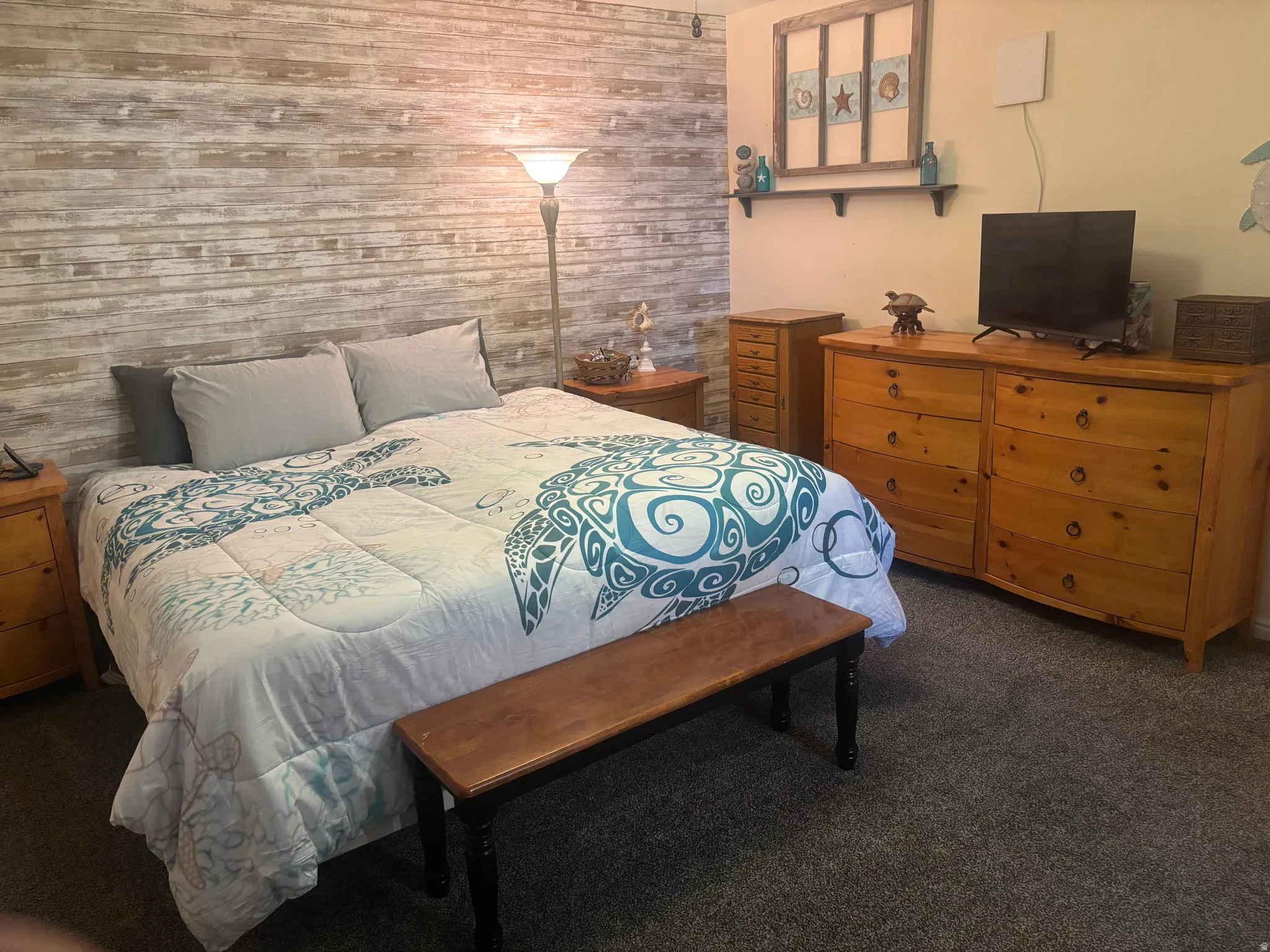 Bedroom featuring dark colored carpet and wooden walls