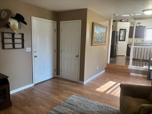 Living area featuring light wood-type flooring and baseboards