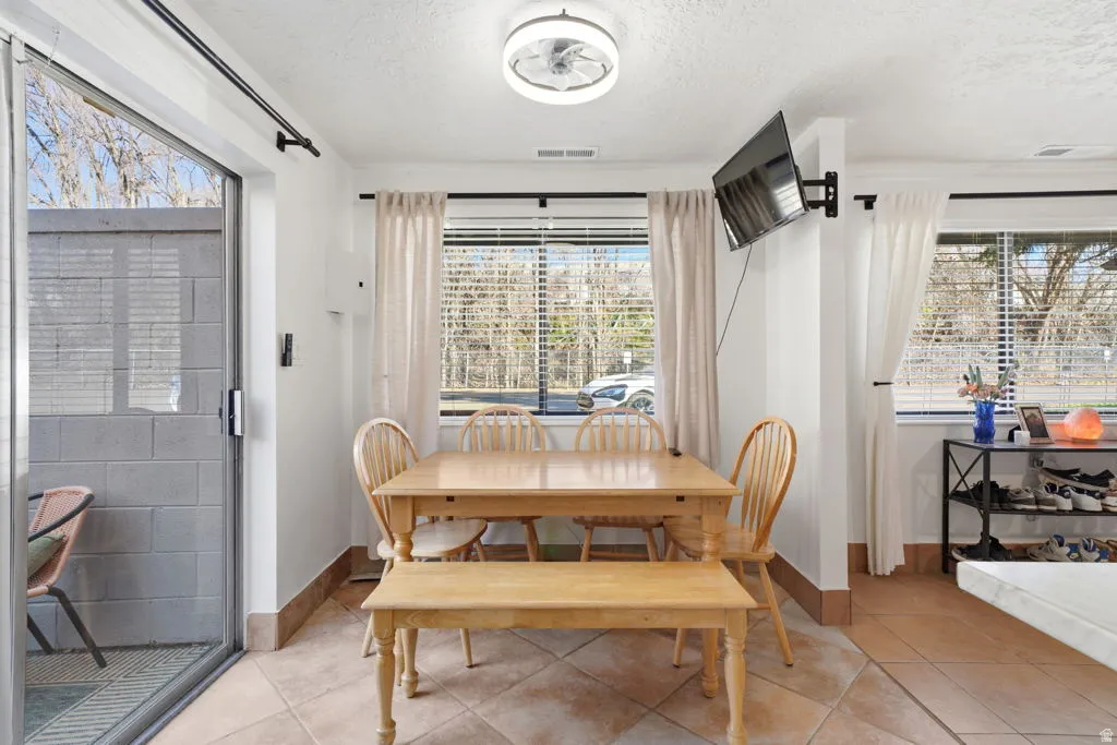 Dining room featuring a textured ceiling and light tile patterned flooring