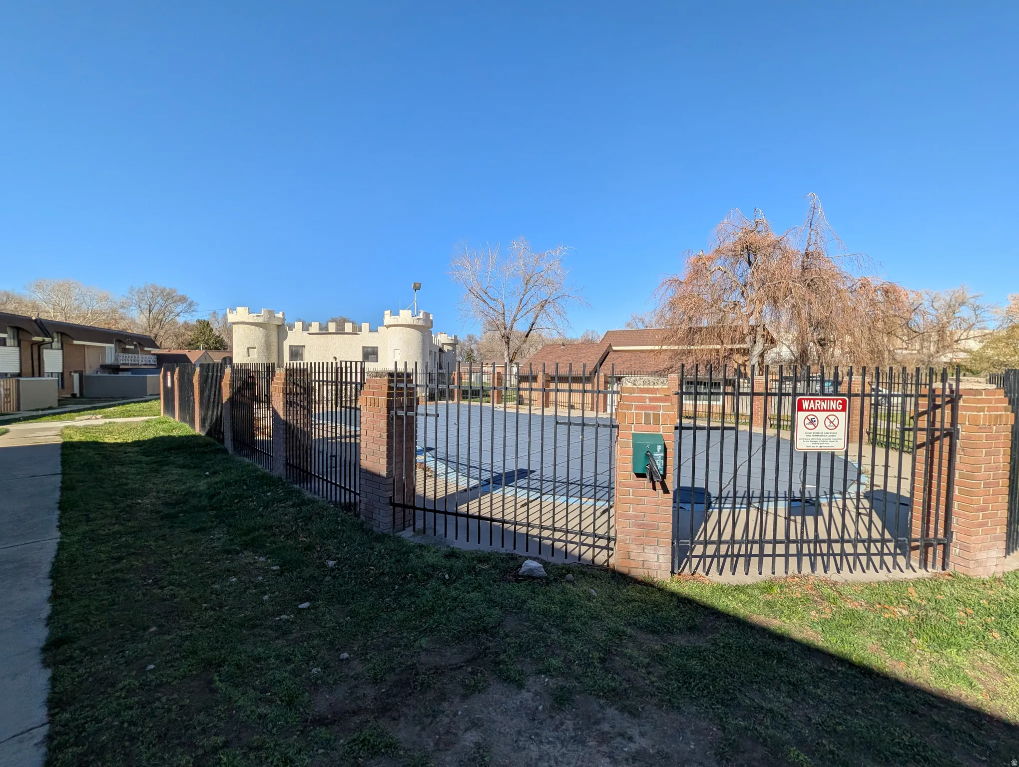 View of swimming pool with a residential view and a gate