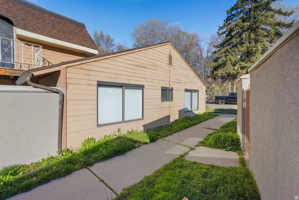 View of property exterior featuring roof with shingles