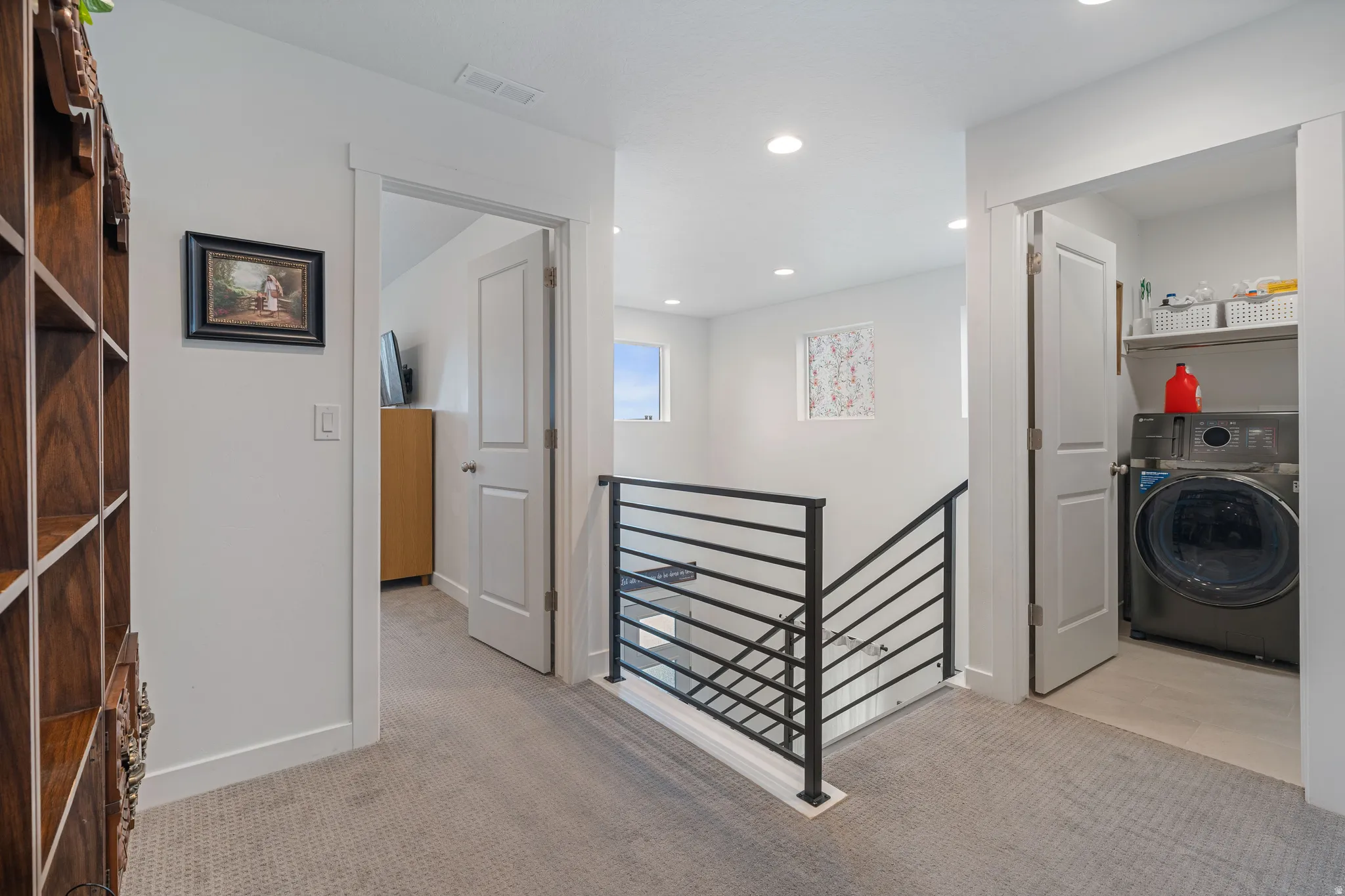 Laundry area with washer / dryer, light carpet, and recessed lighting