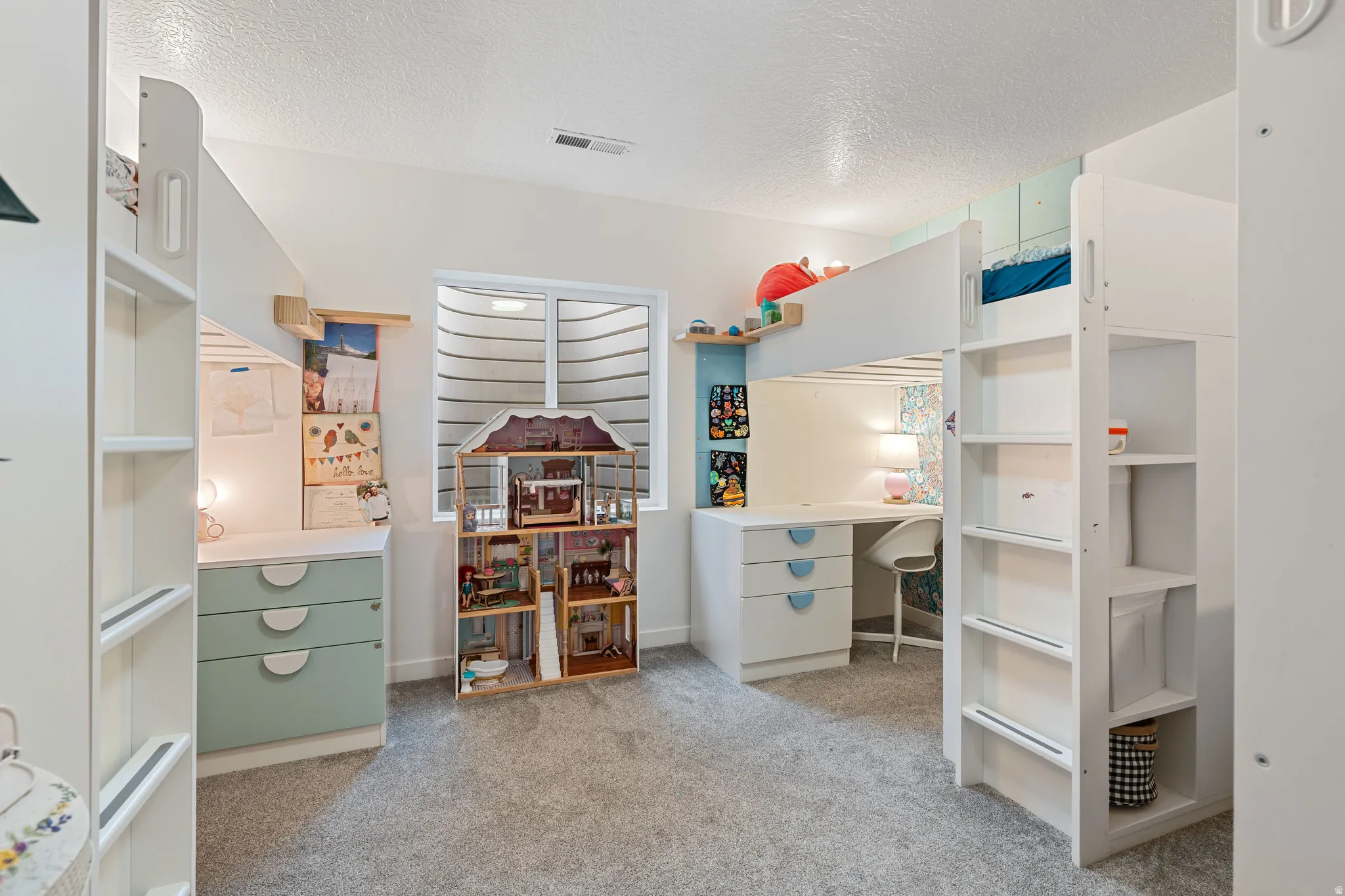 Bedroom featuring light colored carpet and a textured ceiling - Beds/desks/storage can be included depending on Buyer's needs.
