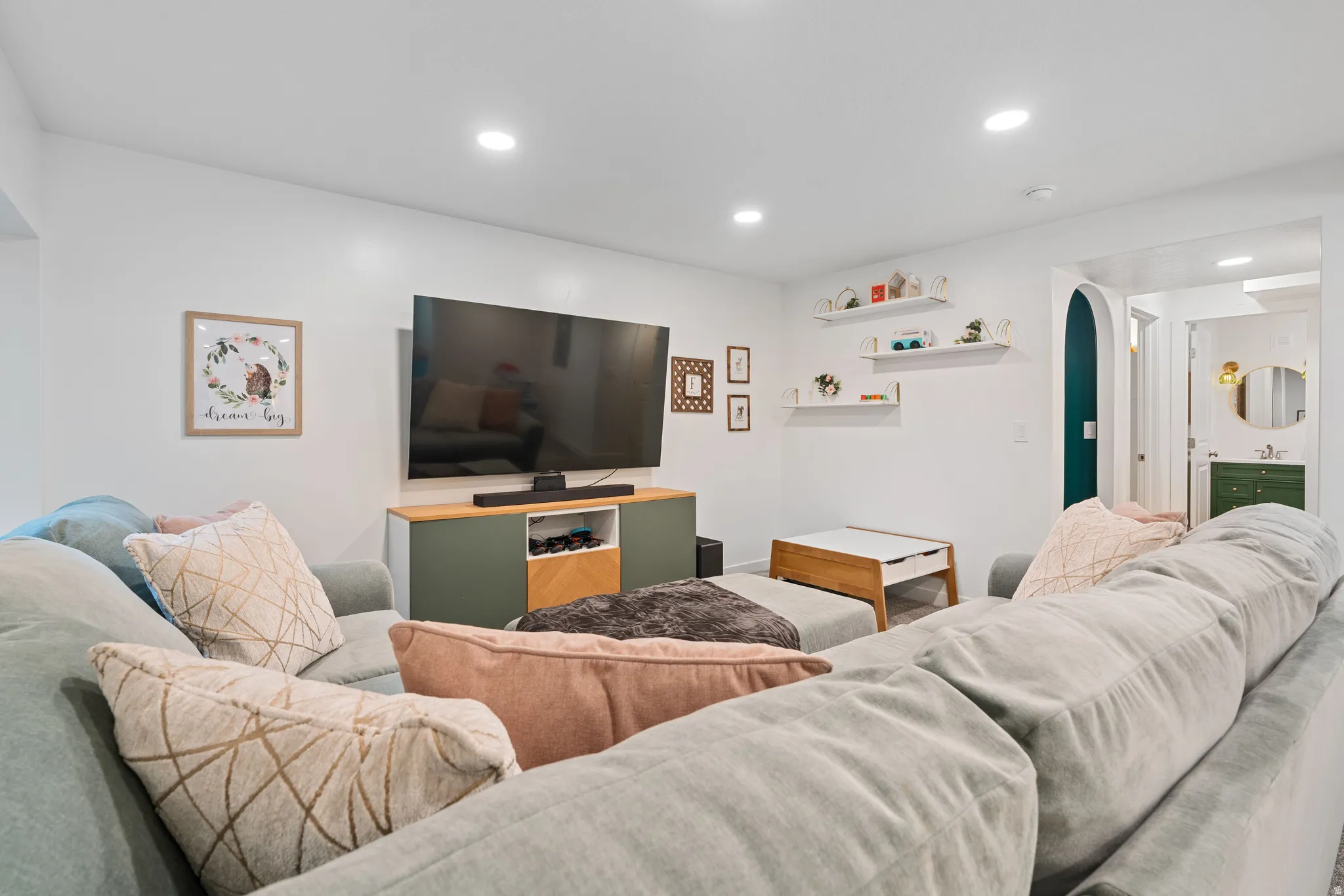 Basement Living area featuring arched walkways and recessed lighting