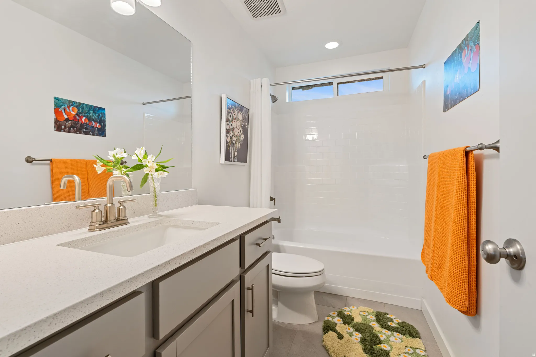 Bathroom featuring vanity, light tile patterned flooring, shower / bathtub combination, and recessed lighting