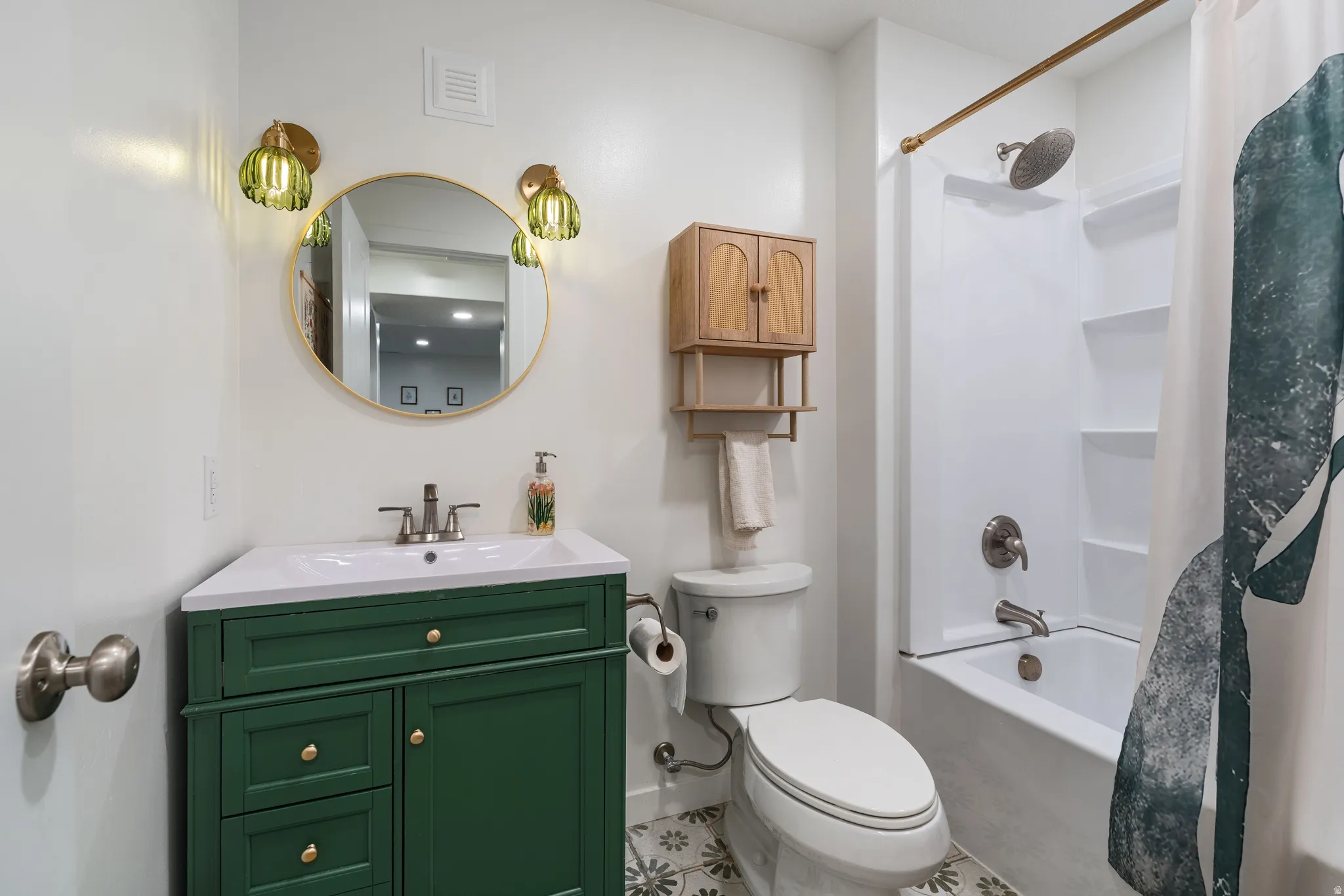 Bathroom with vanity and shower / bath combo