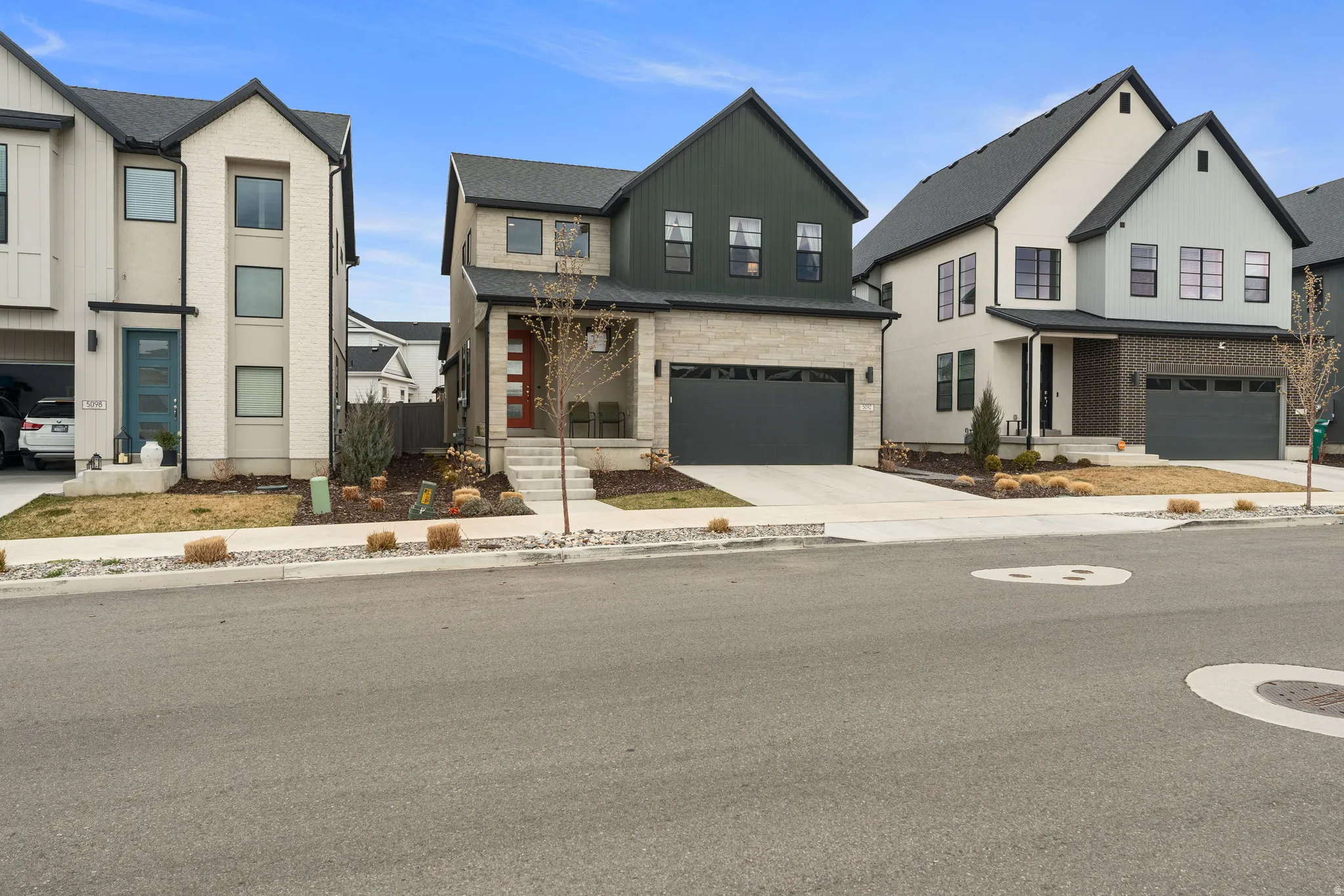 Modern inspired farmhouse with a garage and driveway