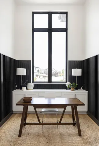 Office space with a wainscoted wall and light wood-style flooring