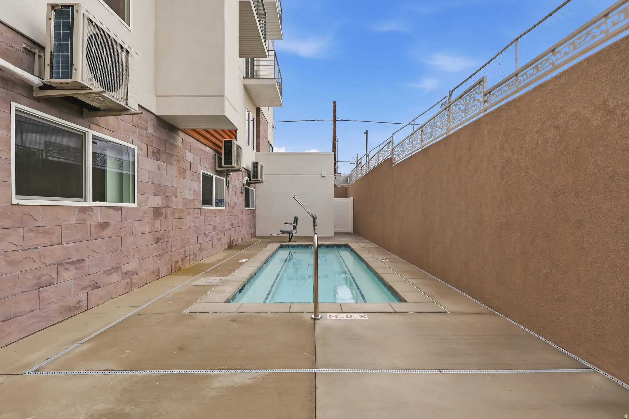 Community heated spa featuring a patio area