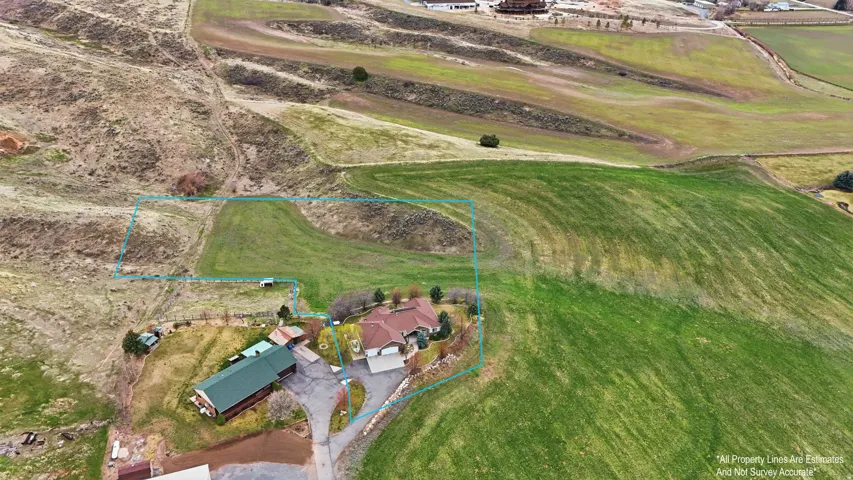 Aerial view of property and surrounding area with property parcel outlined