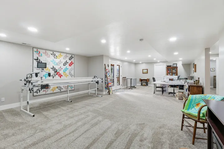 Rec room with light colored carpet and recessed lighting