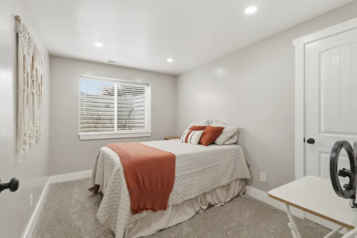 Bedroom with light carpet and recessed lighting