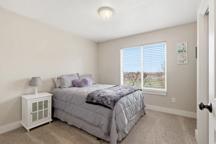 Bedroom featuring light colored carpet