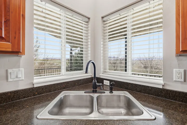 Kitchen view of a sink and wood finish cabinetry