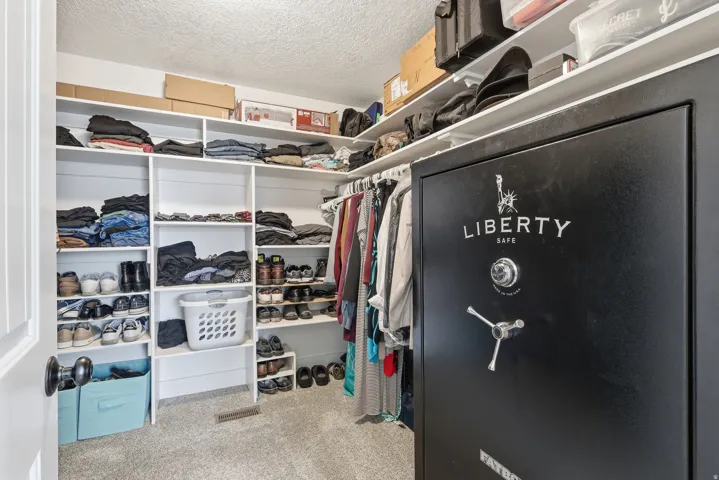 Walk in closet featuring light colored carpet