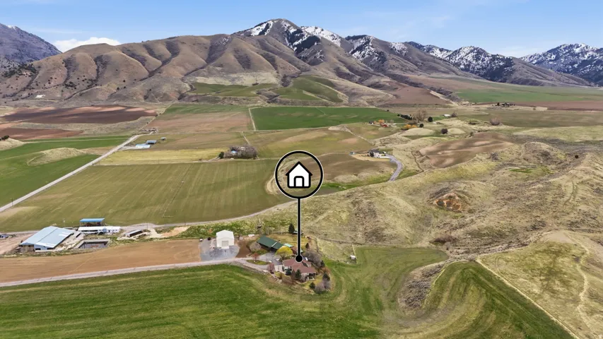 Aerial overview of property's location with a mountain backdrop and rural landscape