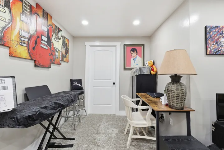 Office area with light colored carpet and recessed lighting